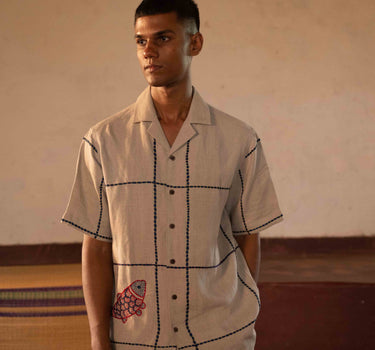 A man in eco-friendly, oh fish! hand-embroidered linen shirt in a yoga hall. half sleeves shirt, Material: linen, front view