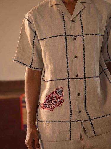 A man in eco-friendly, oh fish! hand-embroidered linen shirt in a yoga hall. half sleeves shirt, Material: linen, front view