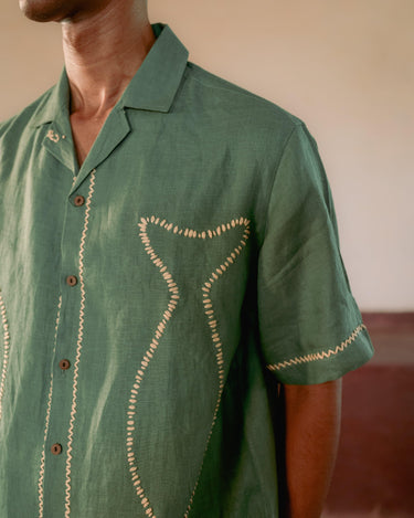 Details of the fish outline in the classy kantha style on a green linen half-sleeved shirt