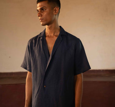 A man in eco-friendly, simple scenes linen shirt in a yoga hall. half sleeves shirt, Material: linen, front view