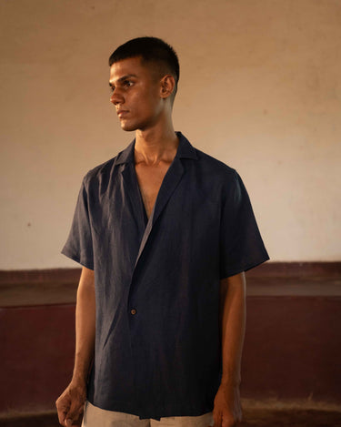 A man in eco-friendly, simple scenes linen shirt in a yoga hall. half sleeves shirt, Material: linen, front view