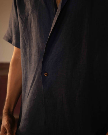 A man in eco-friendly, simple scenes linen shirt in a yoga hall. half sleeves shirt, Material: linen, front view