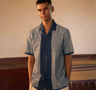 A man in eco-friendly, shades of blue patchwork cotton shirt in a yoga hall. half sleeves shirt, Material: cotton, front view