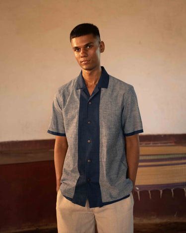 A man in eco-friendly, shades of blue patchwork cotton shirt in a yoga hall. half sleeves shirt, Material: cotton, front view